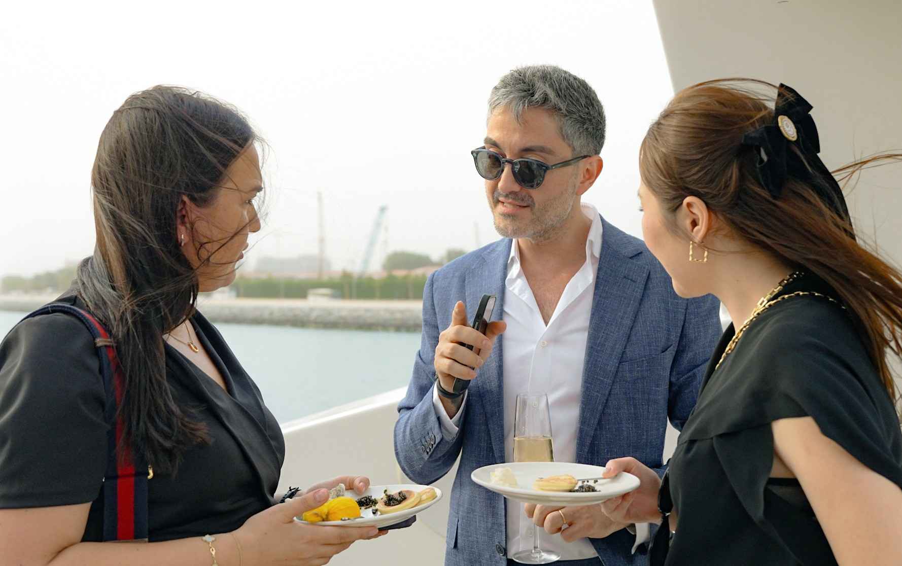 Guests enjoying drinks on the deck of a private yacht