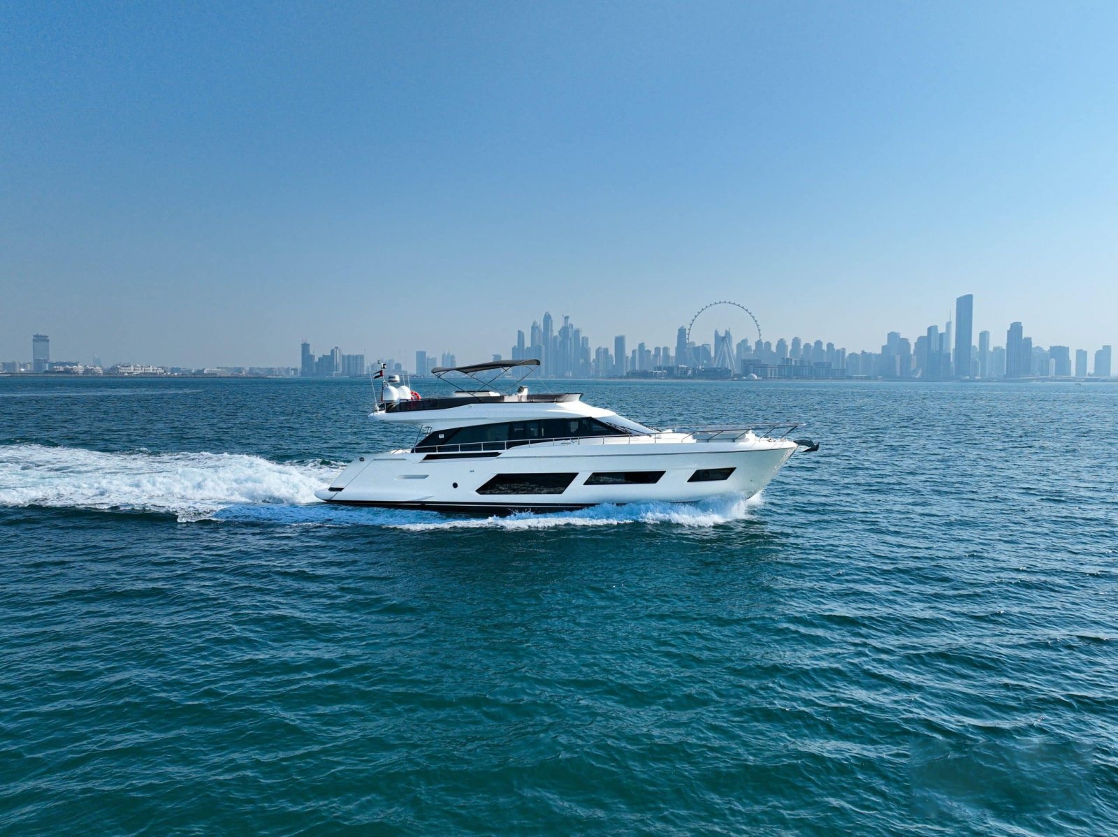 Ferretti 670 cruising off the Dubai Marina skyline and Ain Dubai