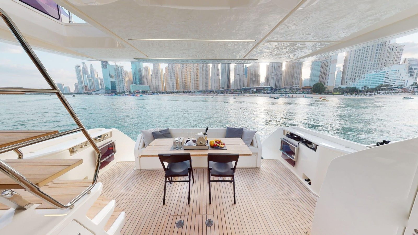 Ferretti 670 aft deck dining table with a JBR view