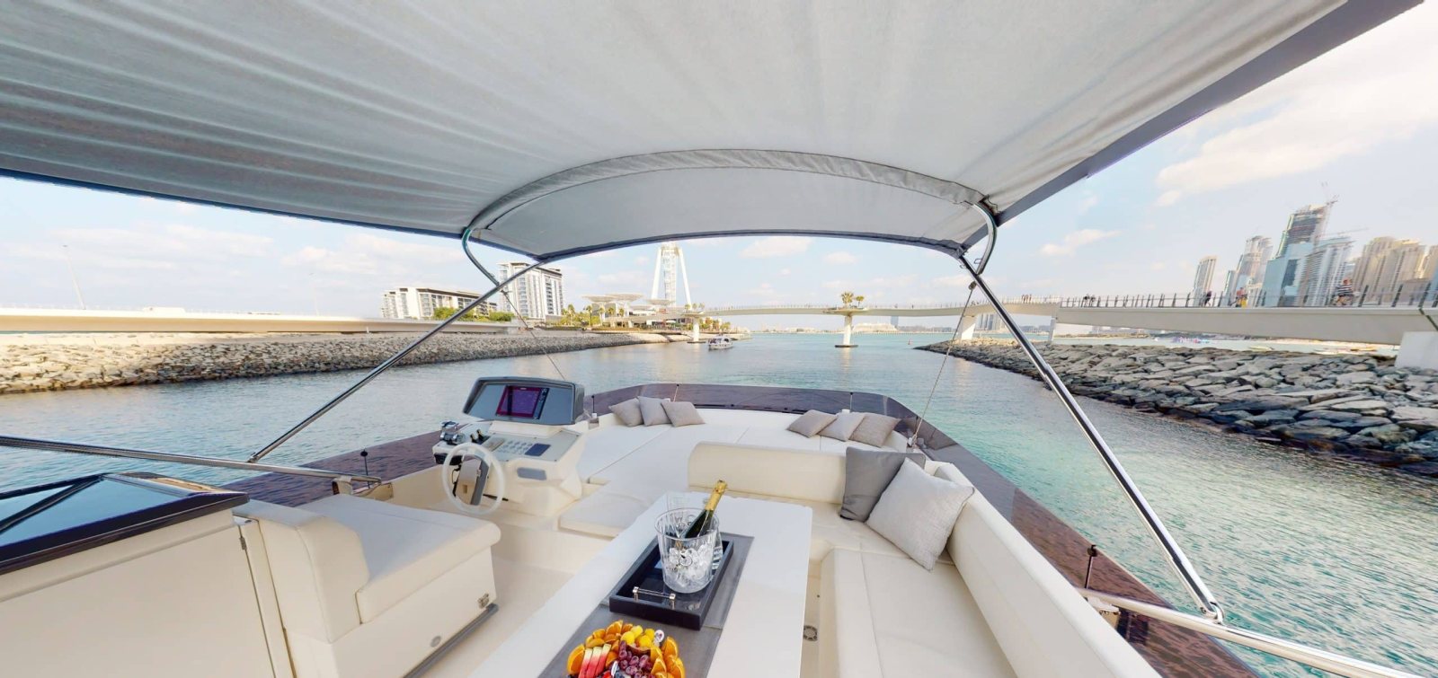 Ferretti 670 flybridge helm and lounge under the bimini