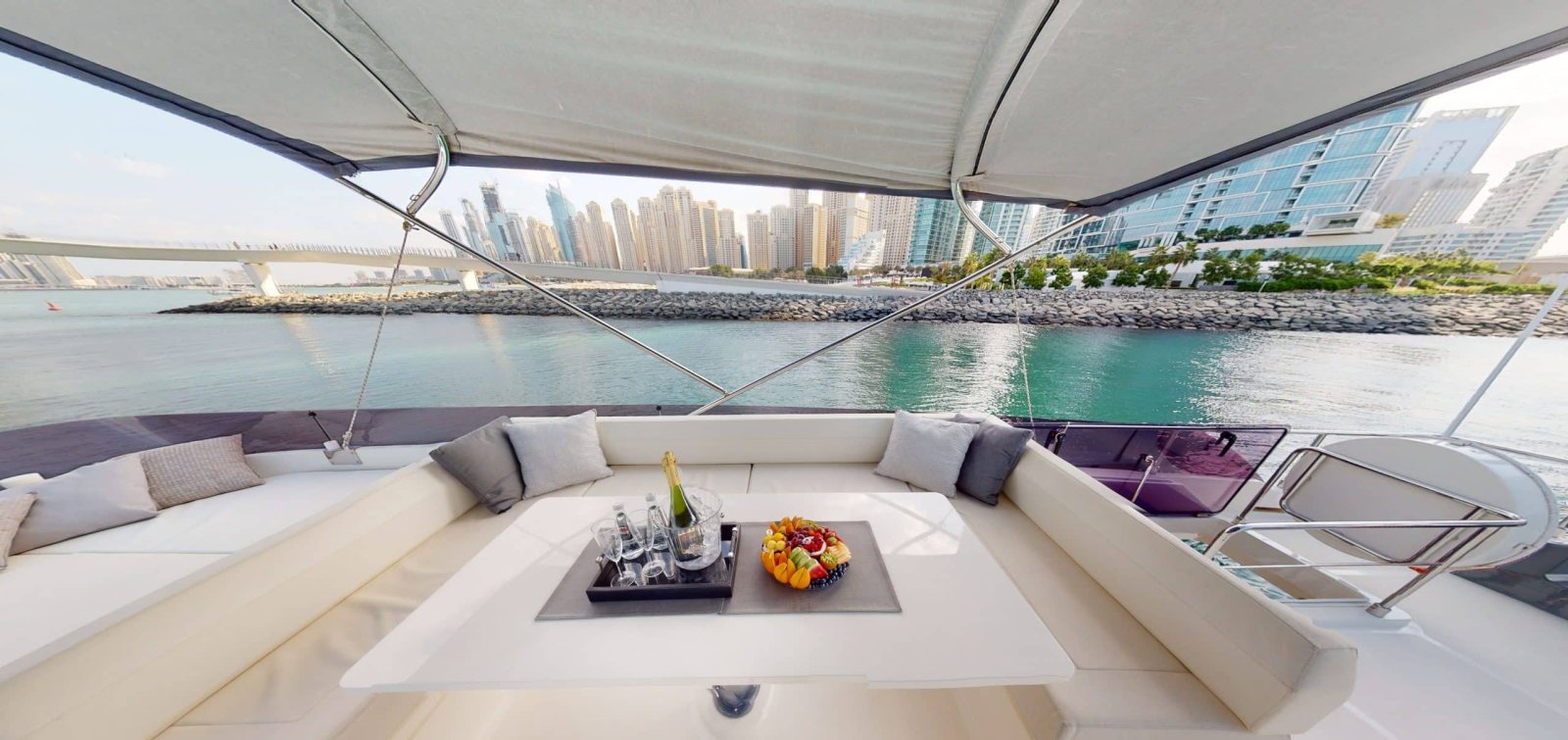 Ferretti 670 flybridge seating and table with the Marina skyline