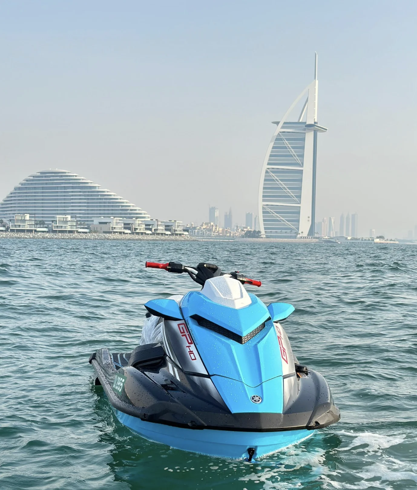 Jet ski on the water off Dubai with the Burj Al Arab behind