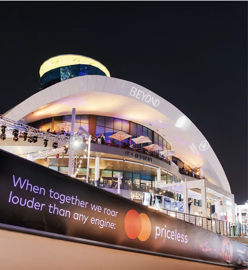 A branded banner in Yas Marina at night during race weekend