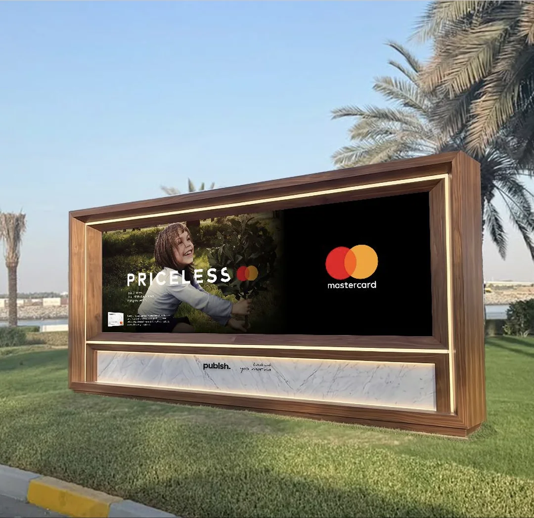 A giant digital screen at the Yas Marina entrance showing a brand during race weekend