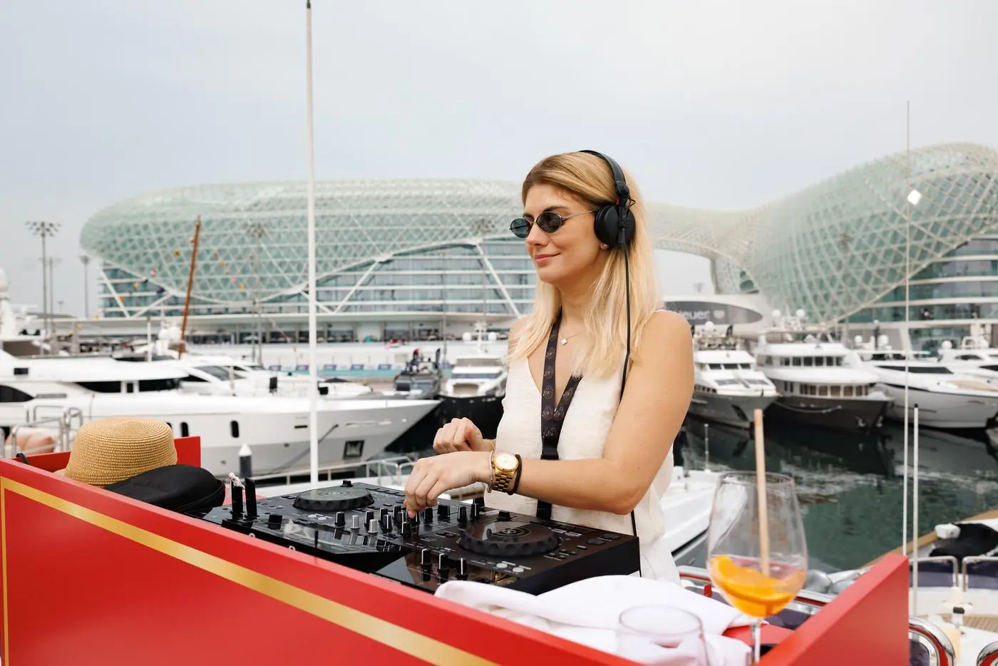 A DJ playing on the deck of a superyacht at Yas Marina