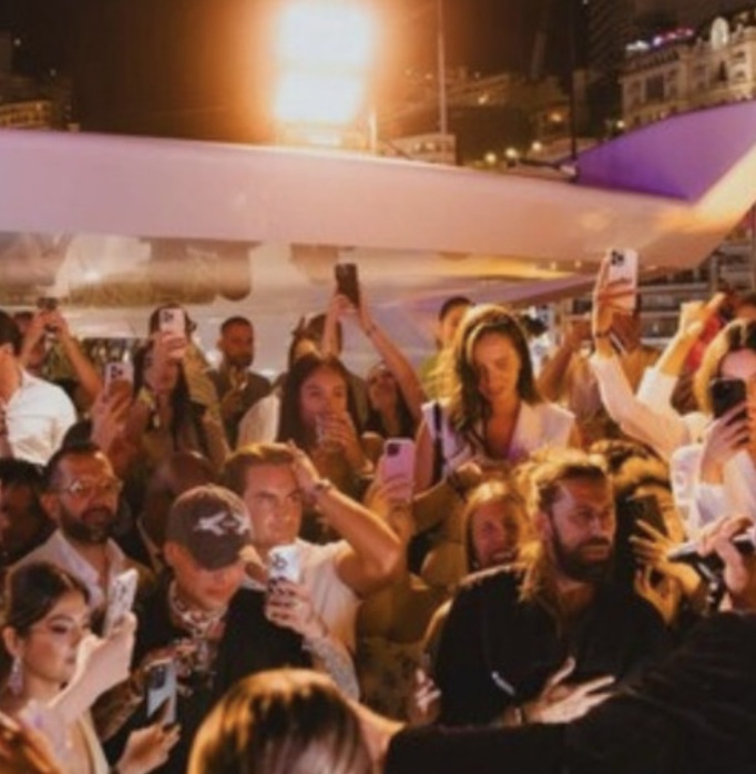 Guests filming the after-party on the megayacht deck at night