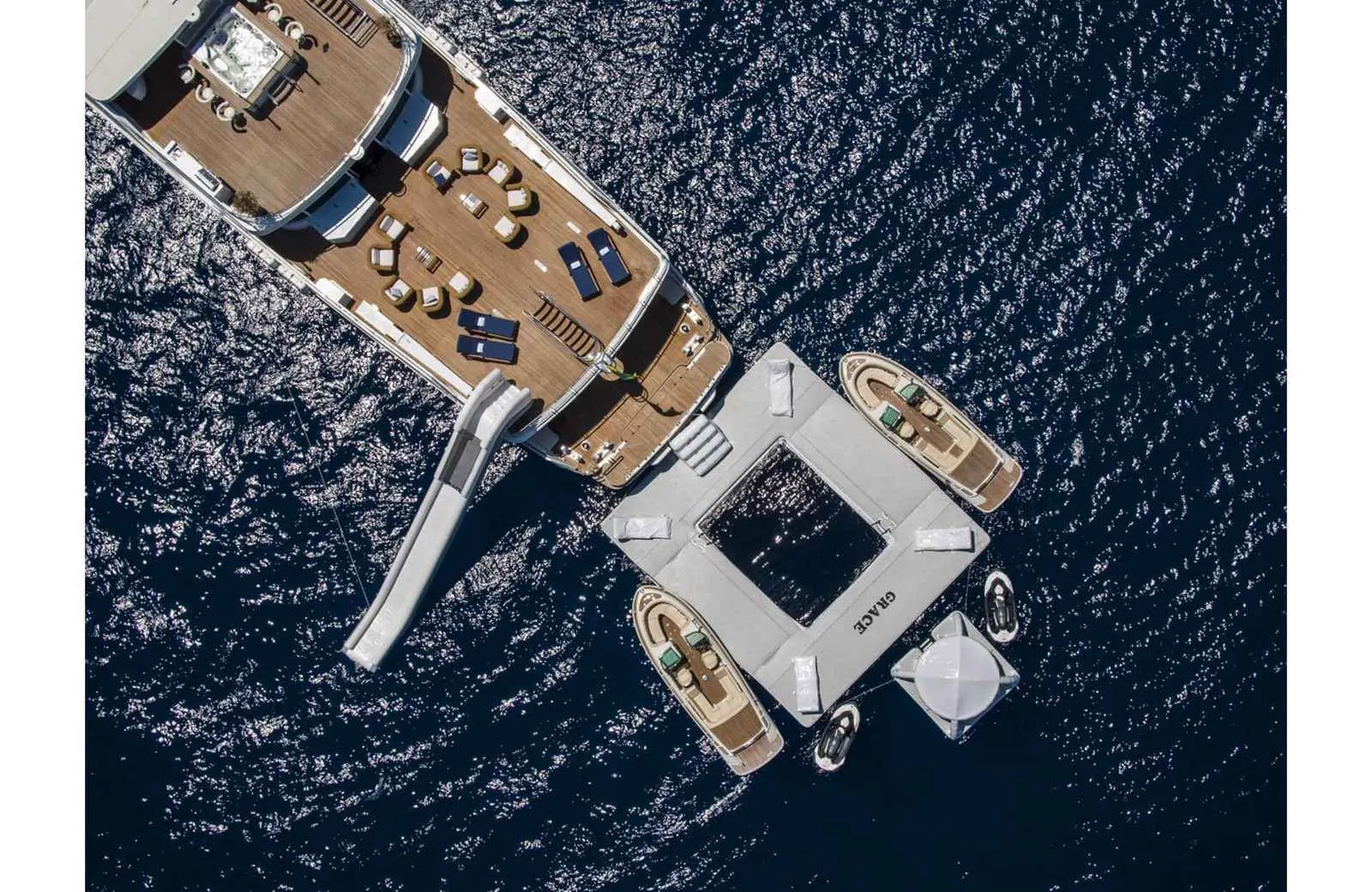 Grace superyacht from above with sea pool and slide, Formula 1 hospitality yacht