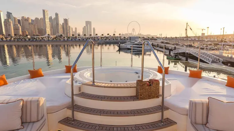A yacht cruising in Dubai at sunset