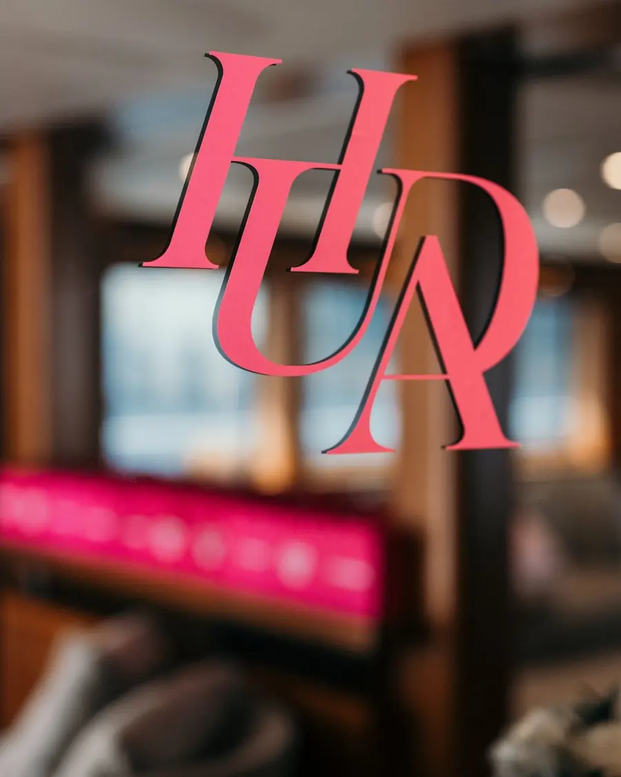 Huda Beauty logo decal on the glass of a yacht salon