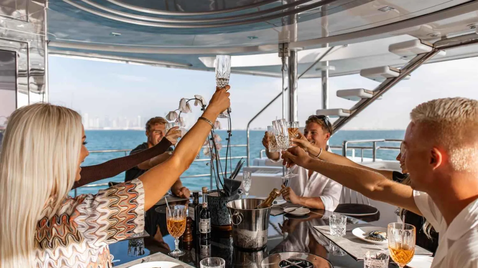 Friends raising their glasses at a birthday party on a yacht in Dubai
