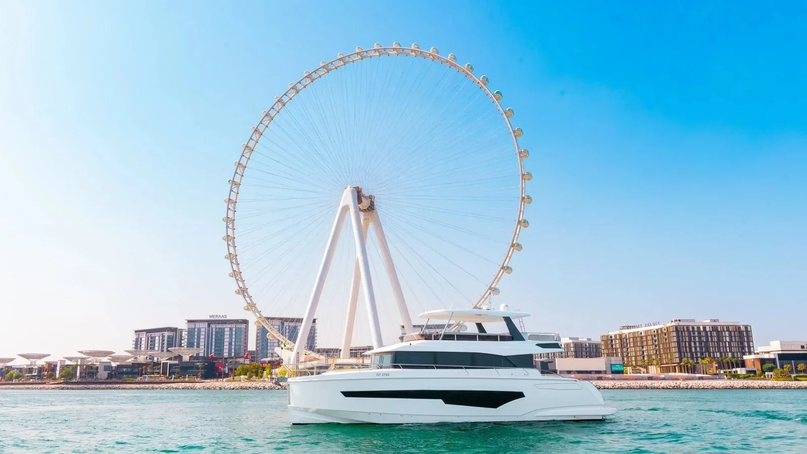 Signature 62 flybridge yacht cruising past Ain Dubai