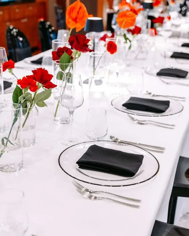 Dinner table set with red roses on a yacht