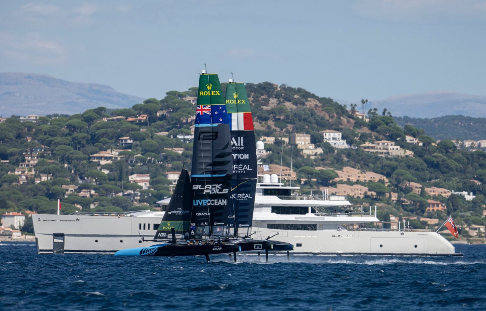 SailGP fleet racing close to the shore