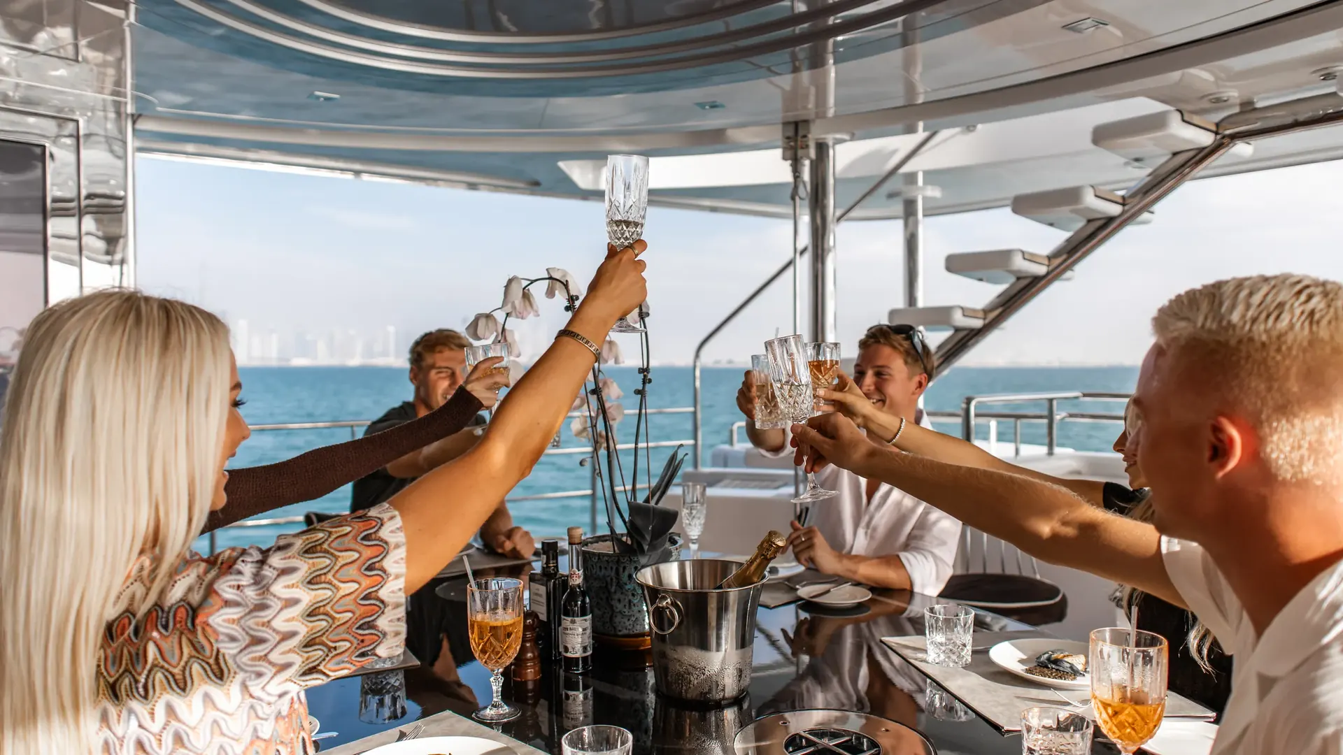 Friends raising a toast at a birthday on a yacht in Dubai
