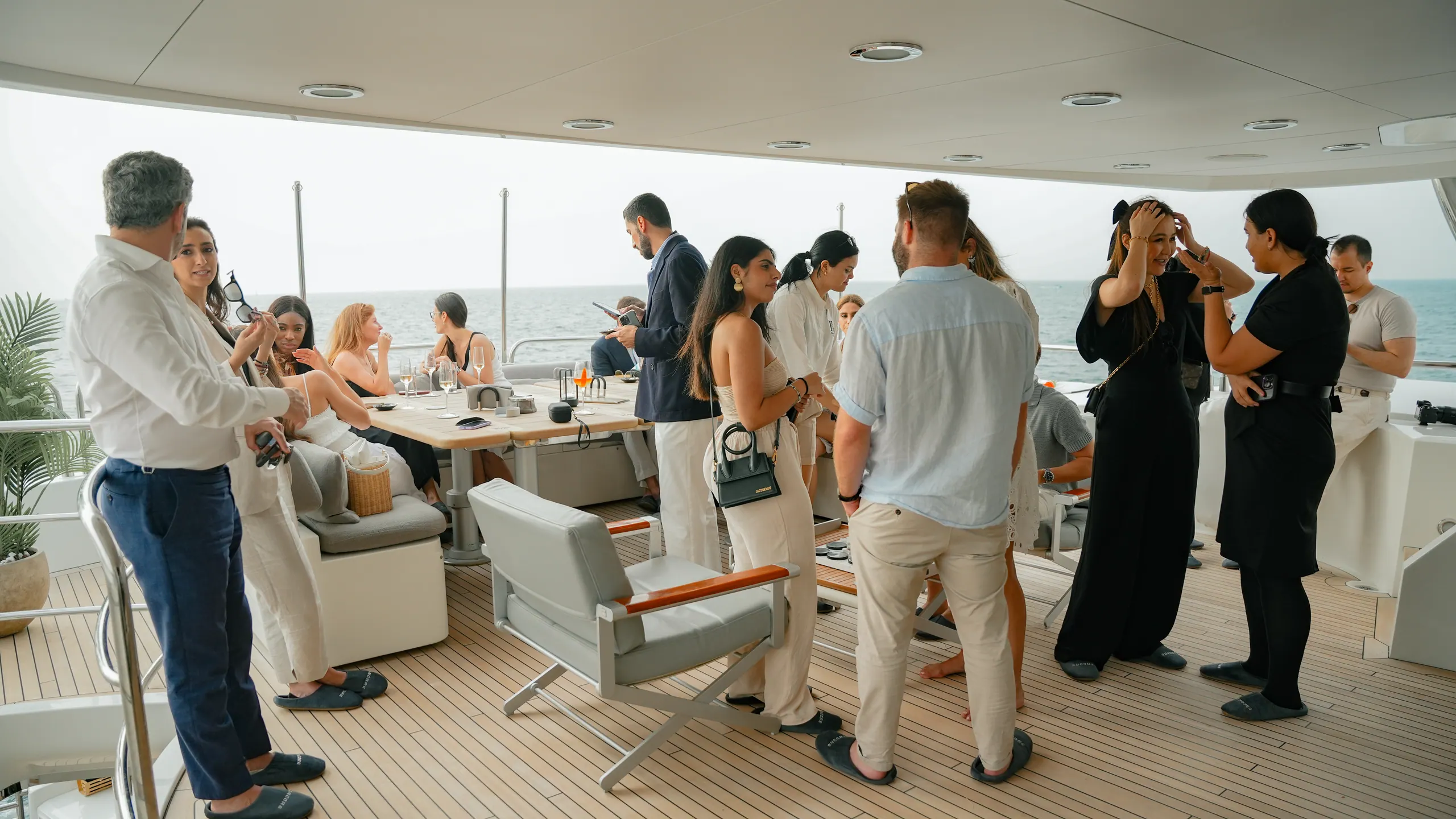 Guests mingling on the deck of a private yacht in Dubai